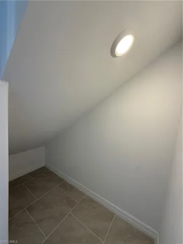 Bonus room featuring lofted ceiling and light tile patterned flooring