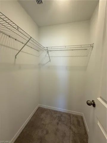 Walk in closet featuring carpet flooring