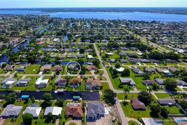 Aerial overview of property's location featuring nearby suburban area and a large body of water