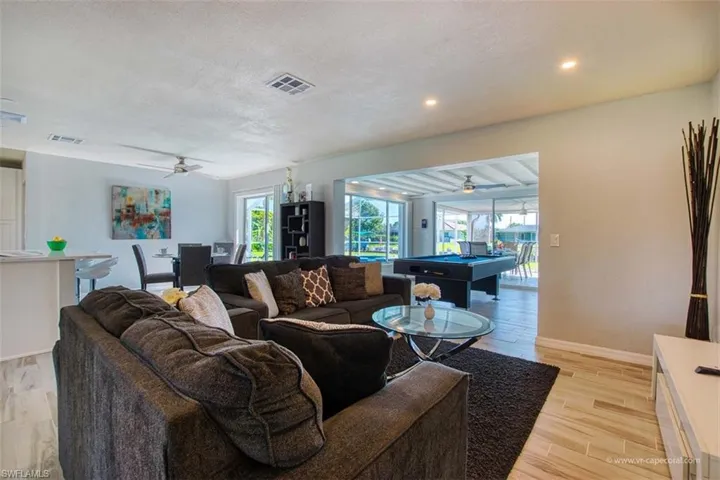 Living room featuring a ceiling fan, wood tiled floors, a textured ceiling, pool table, and recessed lighting