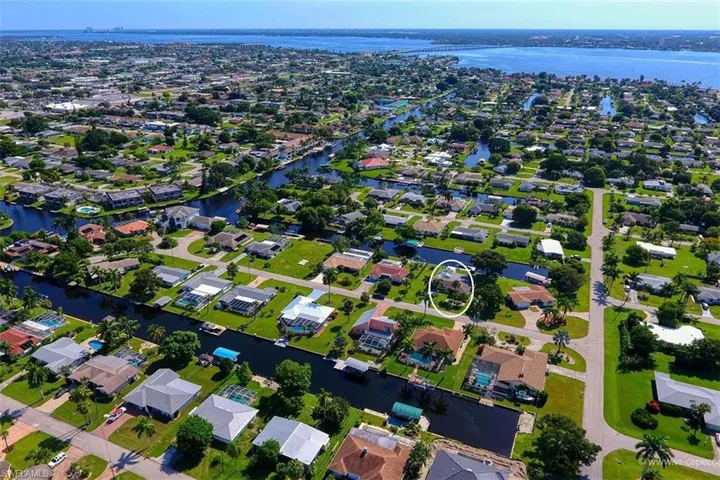 Aerial view of property's location featuring nearby suburban area and a large body of water