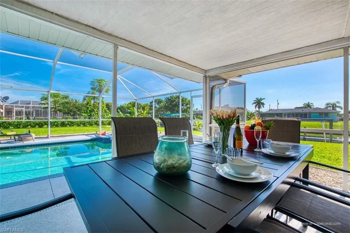 Sunroom with outdoor dining area, plenty of natural light, and a patio