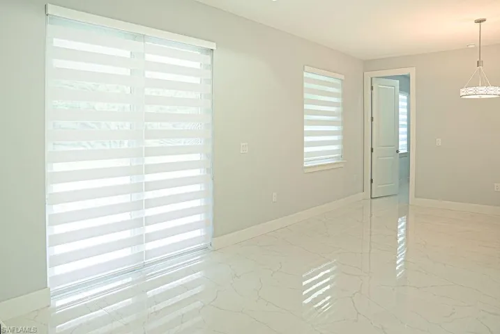 Empty room featuring light marble finish flooring