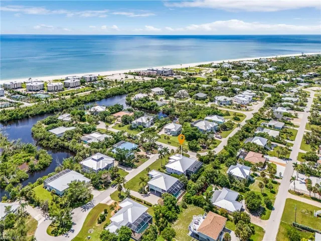 Aerial view of residential area featuring a nearby body of water