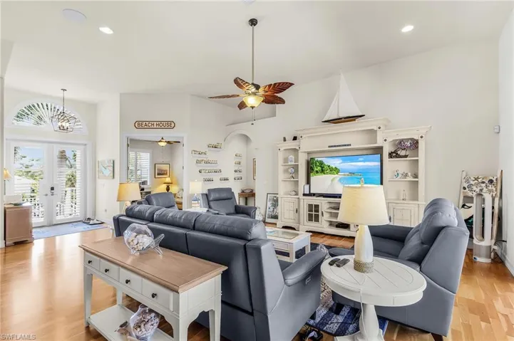 Living room featuring recessed lighting, light wood-style floors, french doors, ceiling fan, and a chandelier