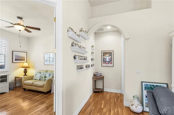 Hallway with light wood-style flooring and healthy amount of natural light