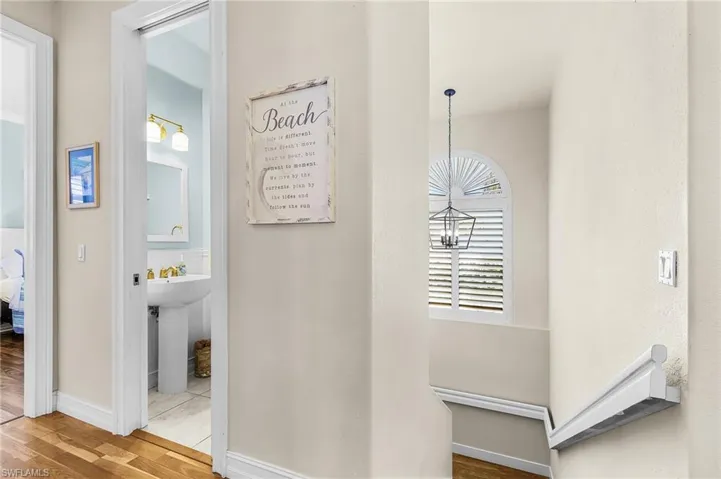 Hallway with wood finished floors and baseboards