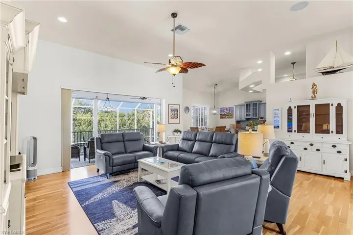 Living room featuring a ceiling fan, recessed lighting, and light wood-style floors