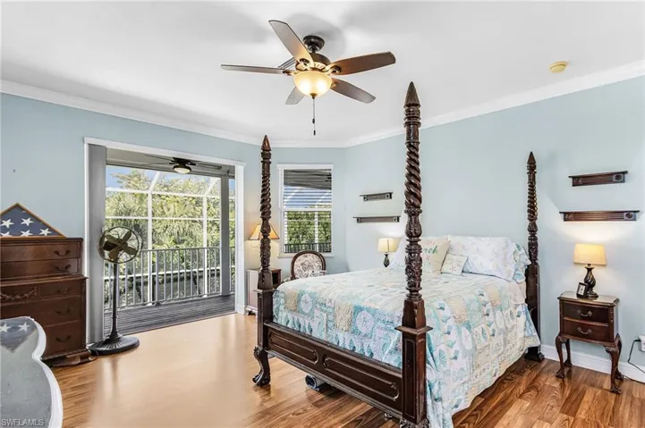 Bedroom featuring crown molding, wood finished floors, access to outside, and ceiling fan