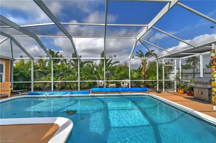 View of swimming pool featuring a patio area, area for grilling, and a lanai