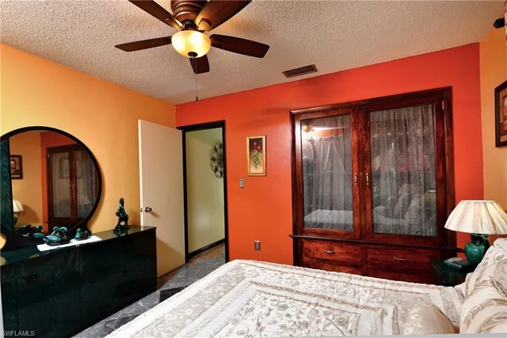 Bedroom featuring a textured ceiling and ceiling fan