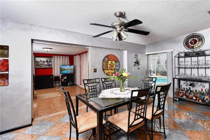 Dining area featuring ceiling fan and a textured ceiling