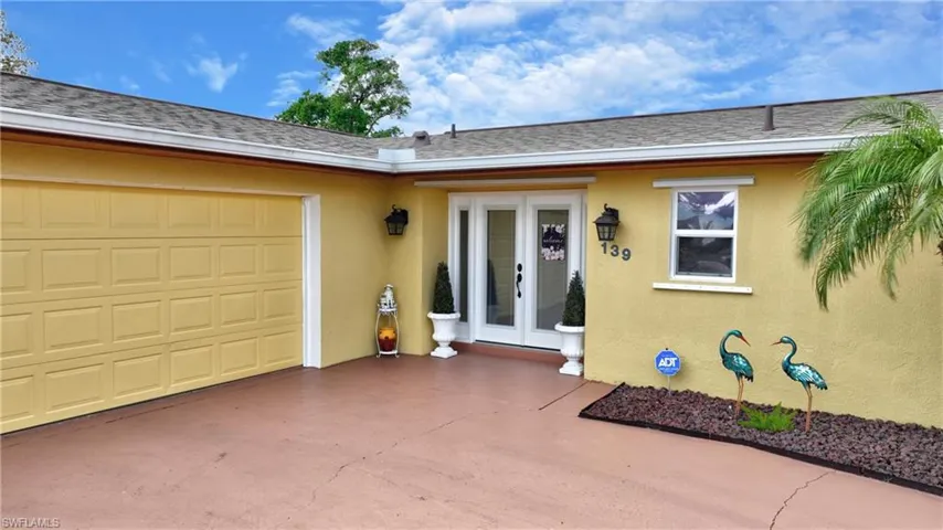 Entrance to property with a garage and french doors