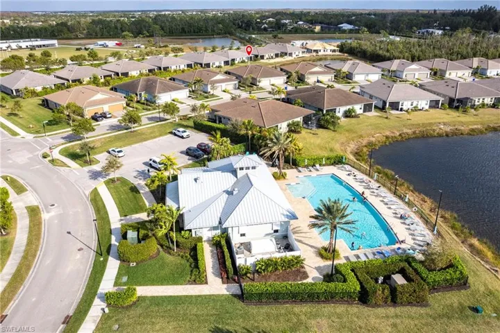 Birds eye view of property with a water view