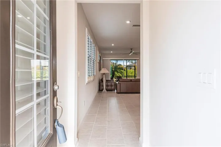 Hallway featuring light tile patterned floors