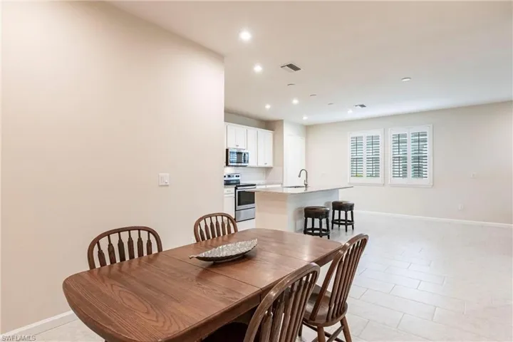 Tiled dining area featuring sink
