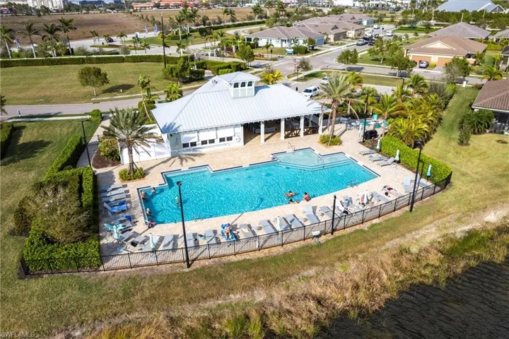 View of swimming pool with a patio and a water view