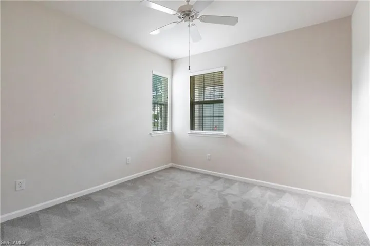 Spare room with ceiling fan and carpet