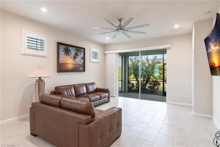 Tiled living room featuring ceiling fan