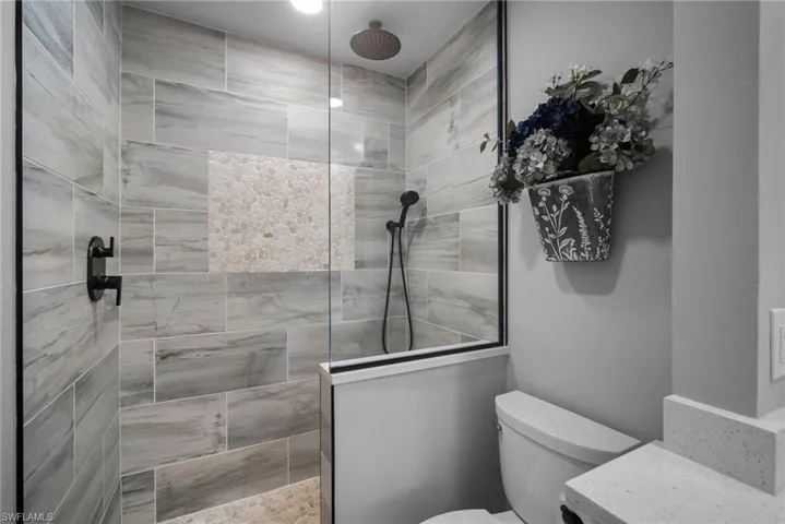 Bathroom with new tiled shower and glass enclosure