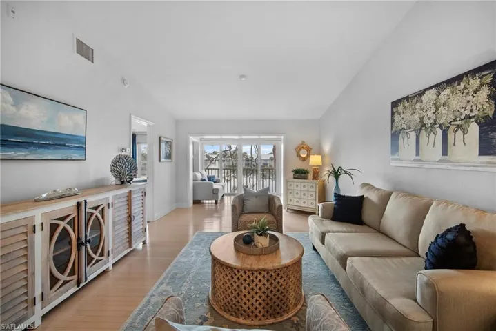 Living room featuring vaulted ceiling and wonderful view of the lake & fountain