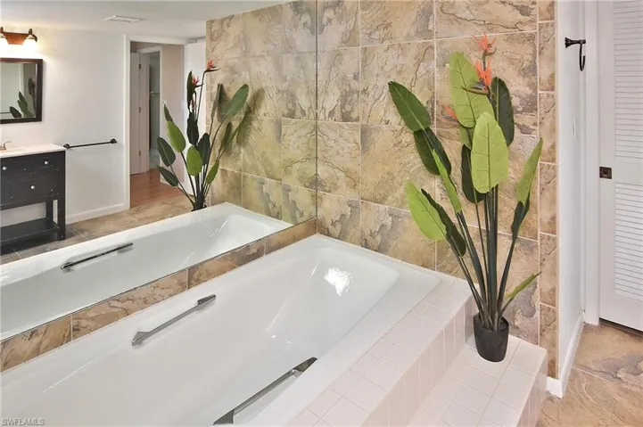Full bathroom with a bath and vanity
