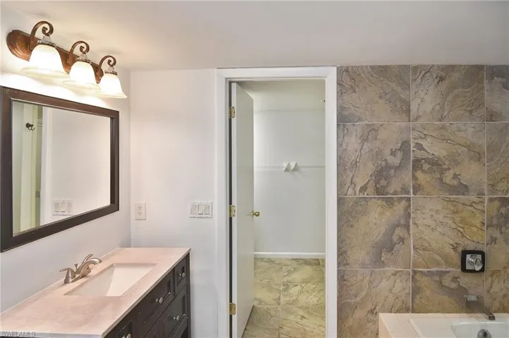 Bathroom with vanity and a tub to relax in