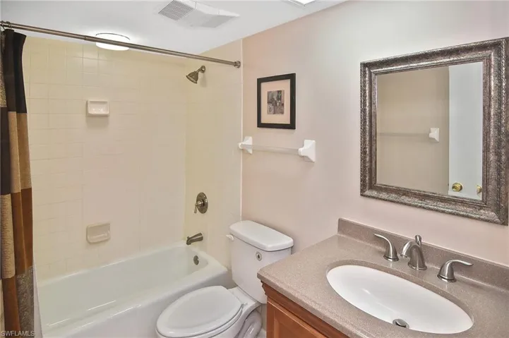 Full bathroom with shower / bathtub combination with curtain and vanity