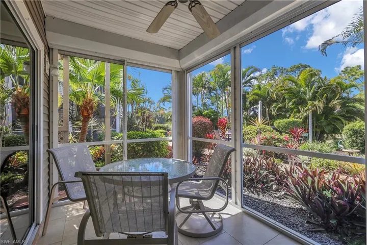Sunroom / solarium with tile patterned floors and plenty of natural light