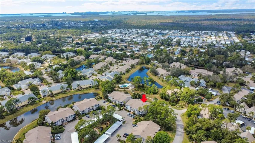 Aerial view of property's location with nearby suburban area and a large body of water