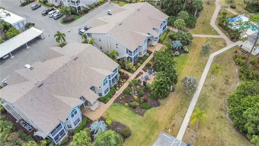 See landscaping and neighbor gathering spot with barbeque grills.