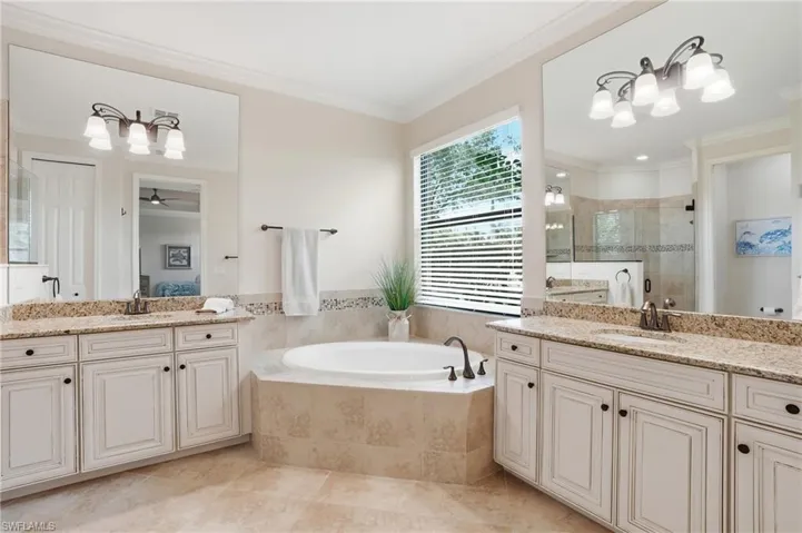 Primary Bath features a soaking tub and dual vanities