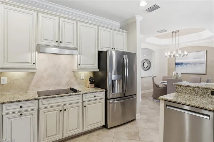 The detailed upgraded cabinetry, electric cooktop and stainless steel appliances complete this spacious kitchen