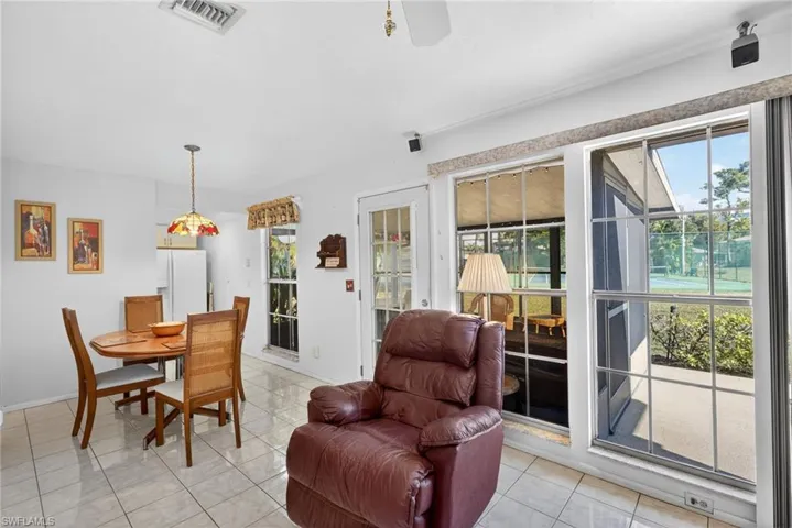 Dining / Living Area has plenty of natural sunlight & views of tennis courts and green space