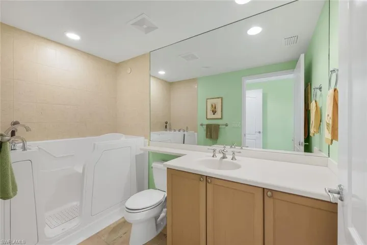 Ensuite guest bathroom features a walk-in tub.