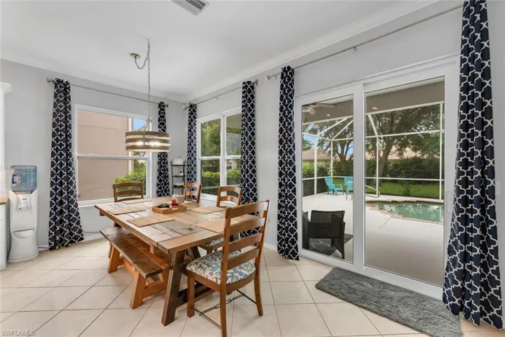 Dining area featuring ornamental molding and light tile patterned floors