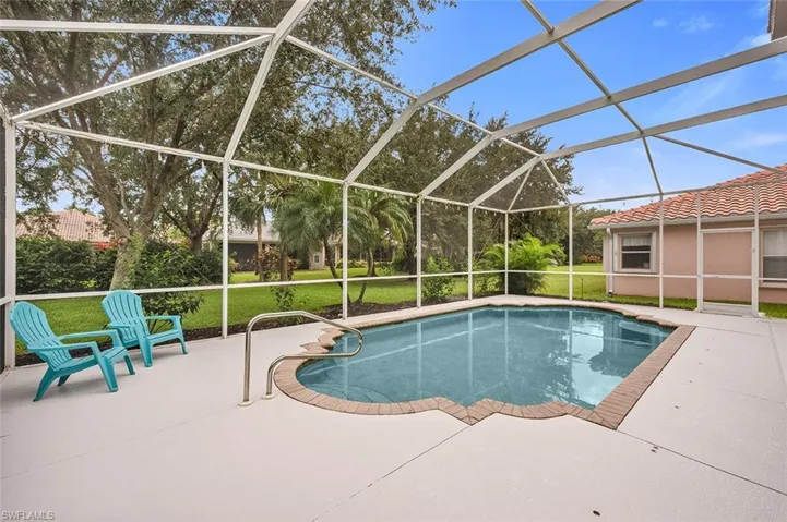 Outdoor pool featuring a lawn, a lanai, a patio, and a sunroom