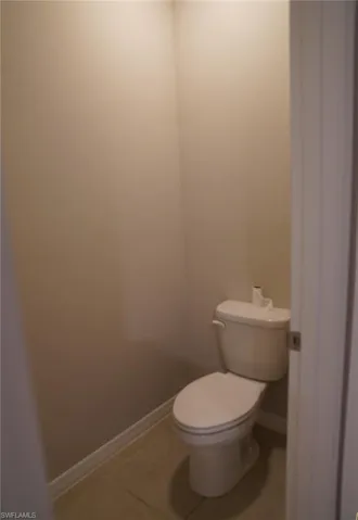 Bathroom with tile patterned flooring and baseboards
