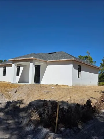 View of side of home with stucco siding