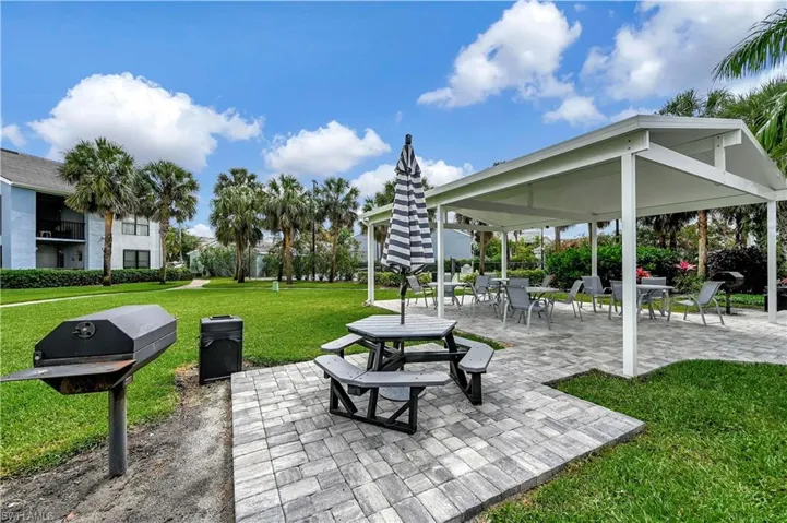 Surrounding community with a gazebo, a patio, and a lawn