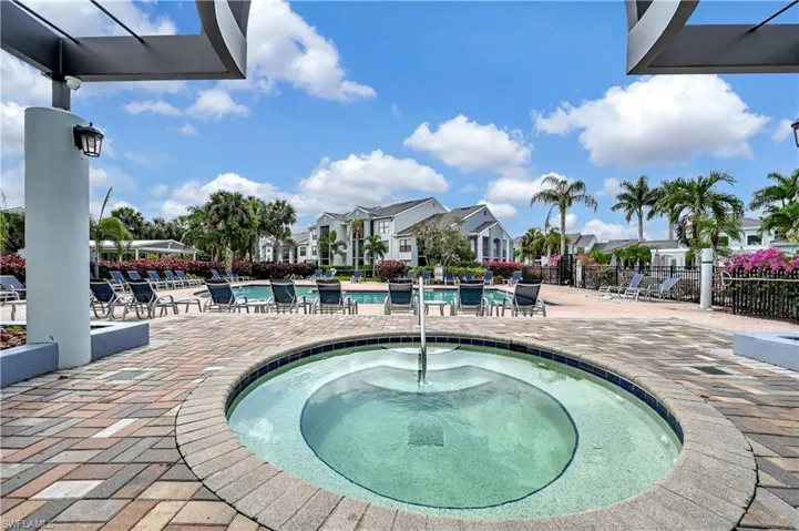 View of pool featuring a hot tub and a patio area