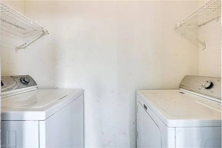 Washroom featuring independent washer and dryer