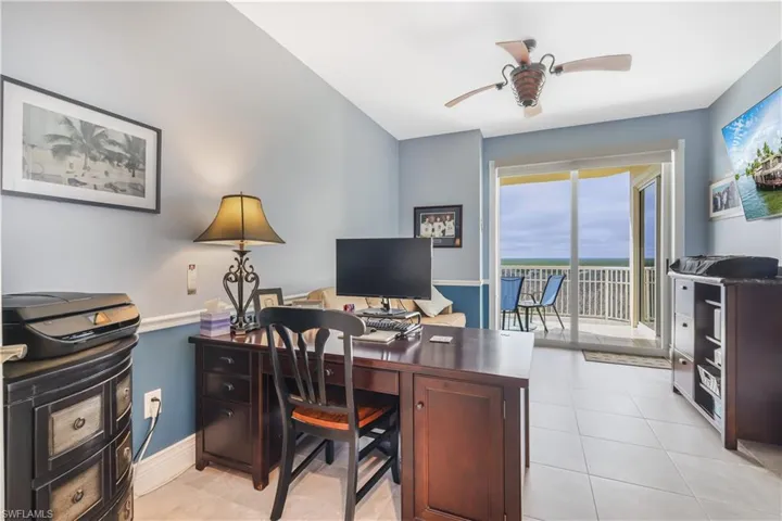 Home office with ceiling fan and light tile patterned flooring