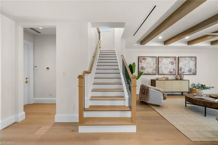 Wood and iron detailed staircase off living room