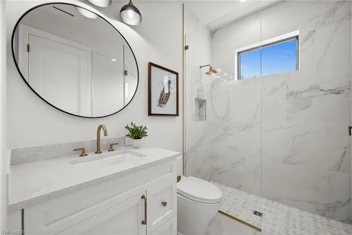 Lower level full bath in ensuite bedroom, porcelain and natural stone, Pompeii upgraded countertops