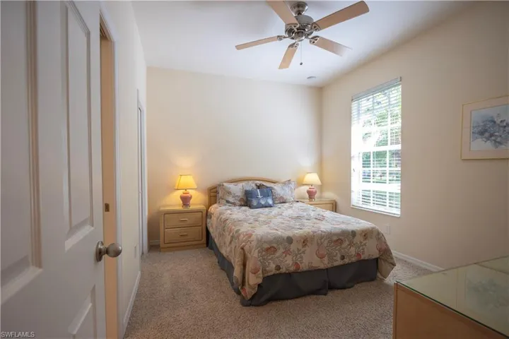 Window with blinds, ceiling fan, and carpeted flooring