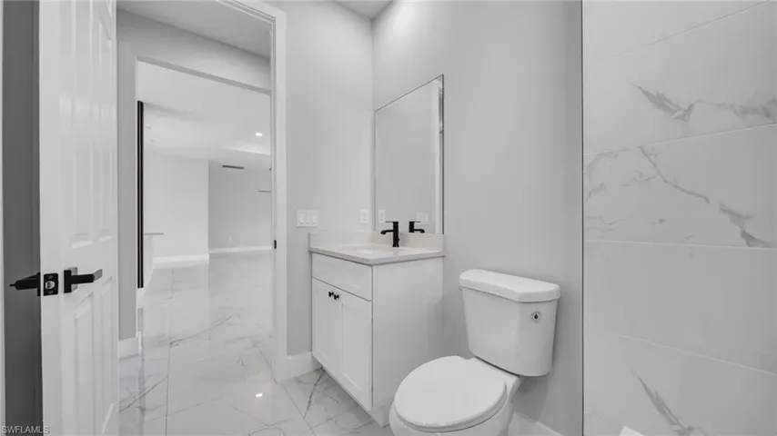 Bathroom featuring marble finish floors and vanity