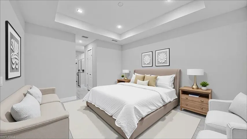 Bedroom with a tray ceiling and recessed lighting