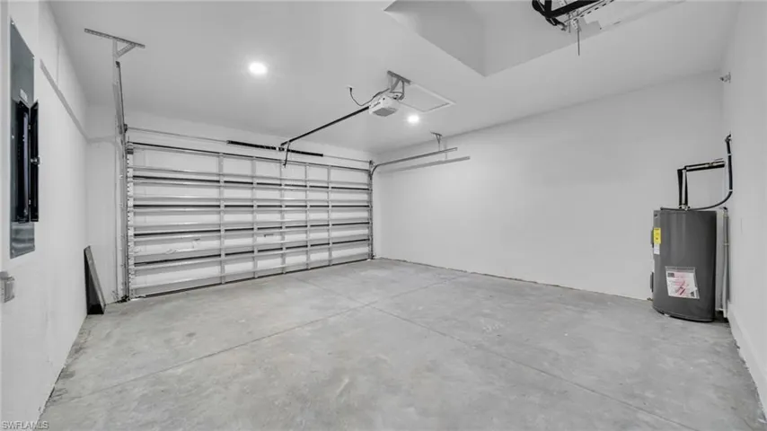 Garage featuring electric water heater
