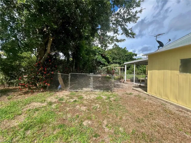 Double gate to fenced backyard.